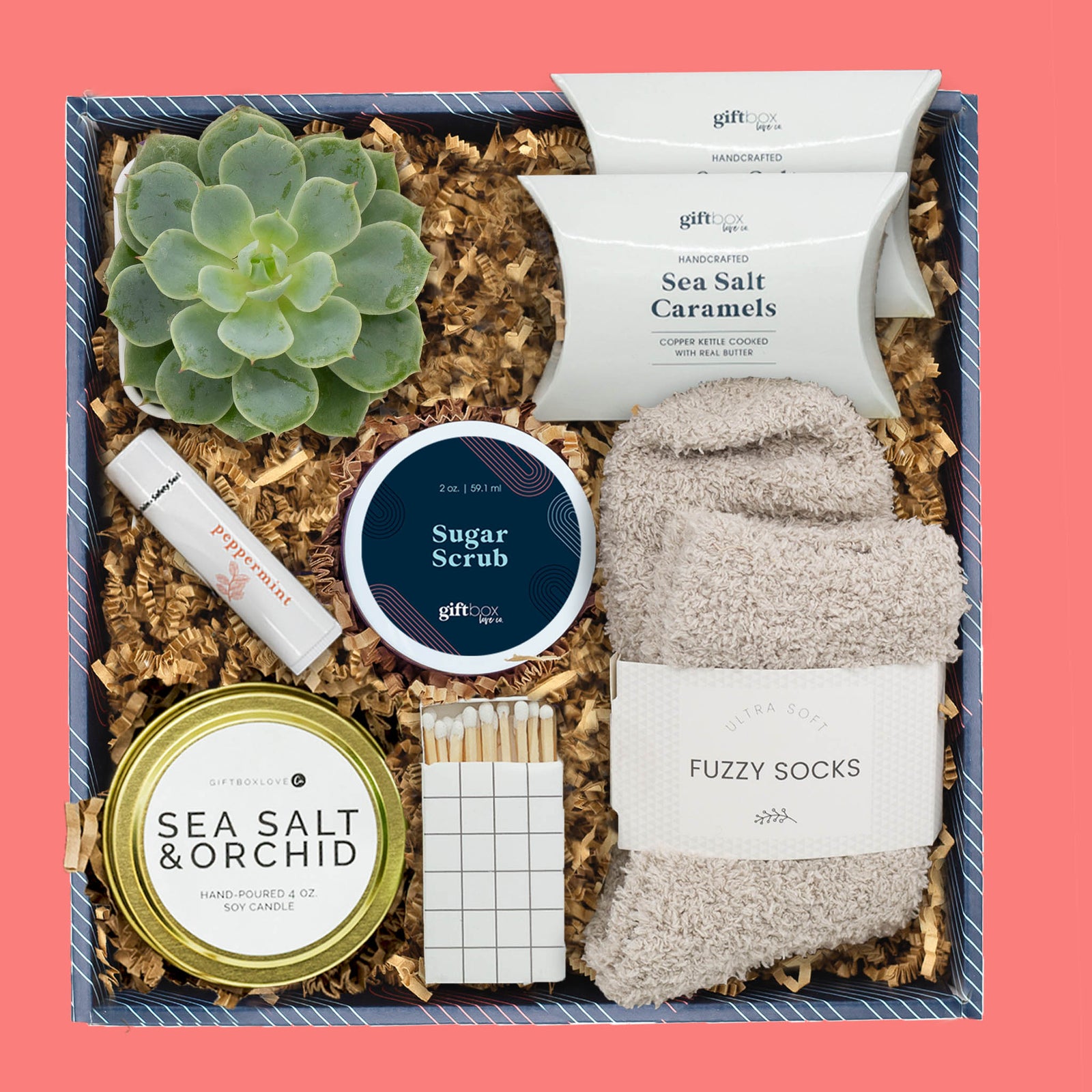 Succulent gift box with candle, socks, sugar scrub, caramels, and self-care items