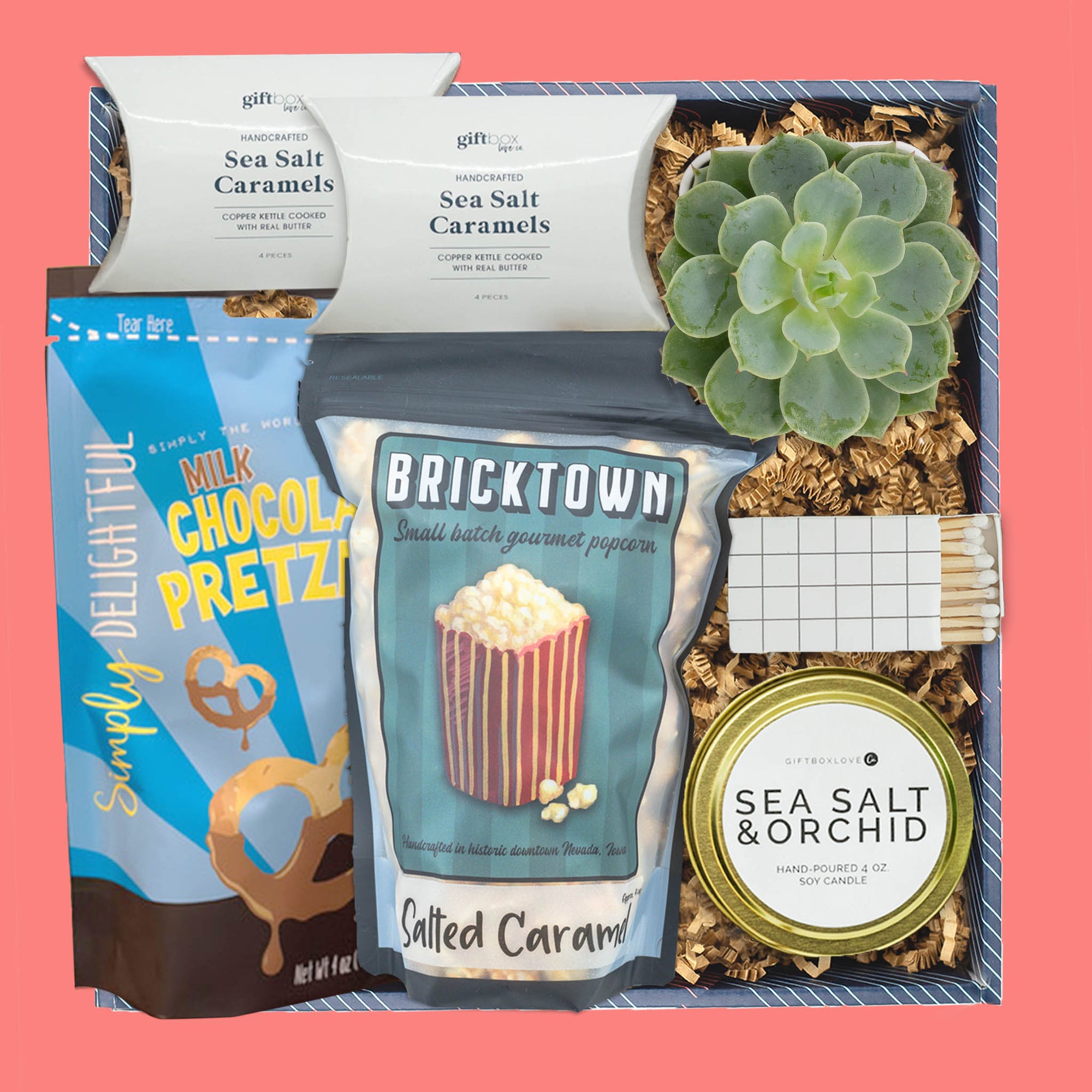 Succulent gift box with chocolate pretzels, caramel popcorn, candle, and caramels