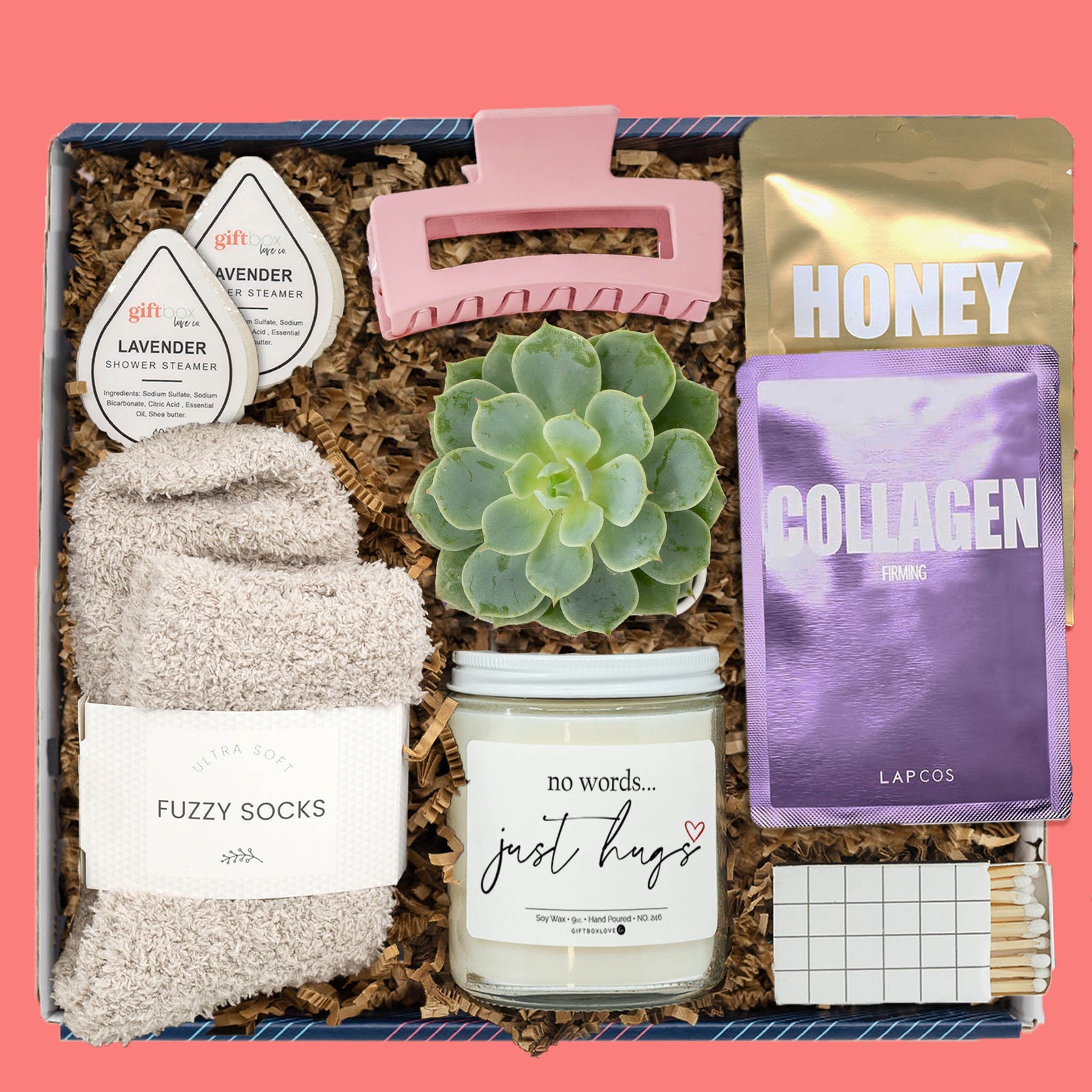 Comfort gift box with fuzzy socks, candle, succulent, sheet masks, shower steamers, pink hair clip, and matches