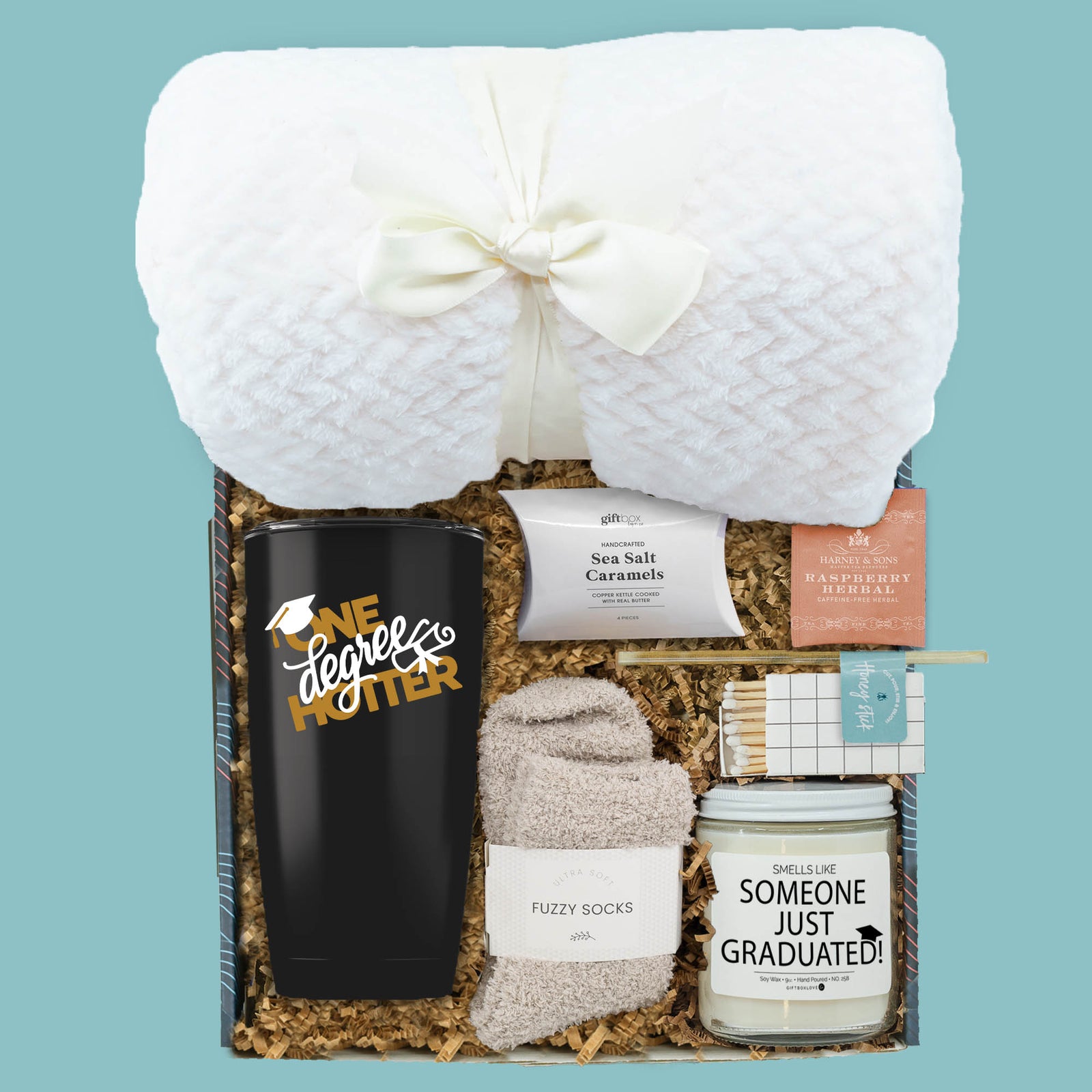graduation gift box with tumbler blanket candle fuzzy socks and tea