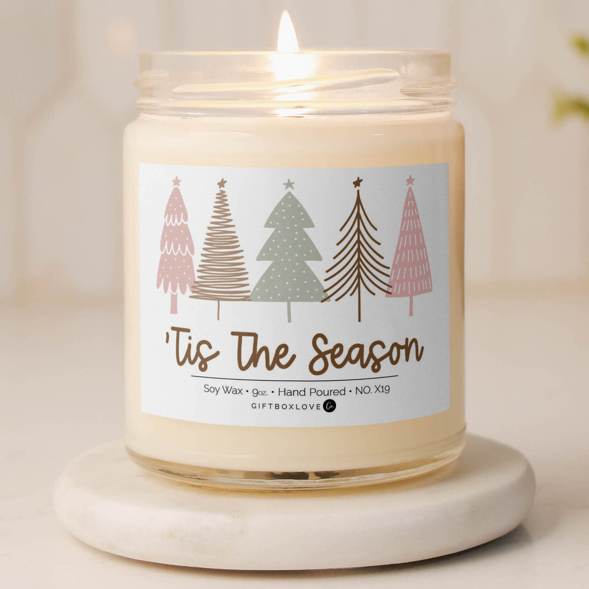 ’Tis the Season pastel candle with soft Christmas tree design and golden lettering