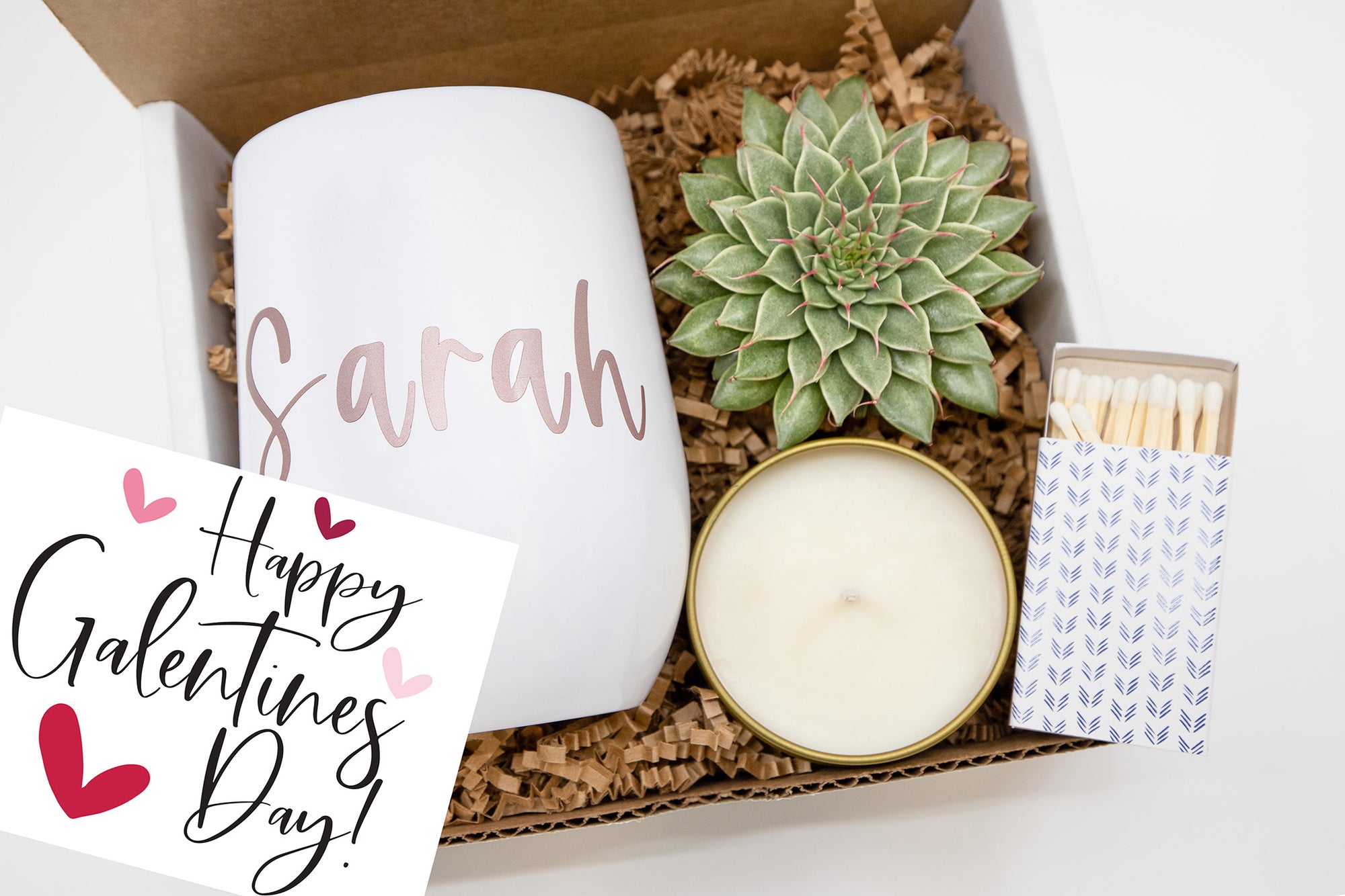 Valentine’s Day Galentine Gift Box featuring a live succulent, hand-poured soy candle, personalized wine tumbler, decorative matches, and handwritten card.