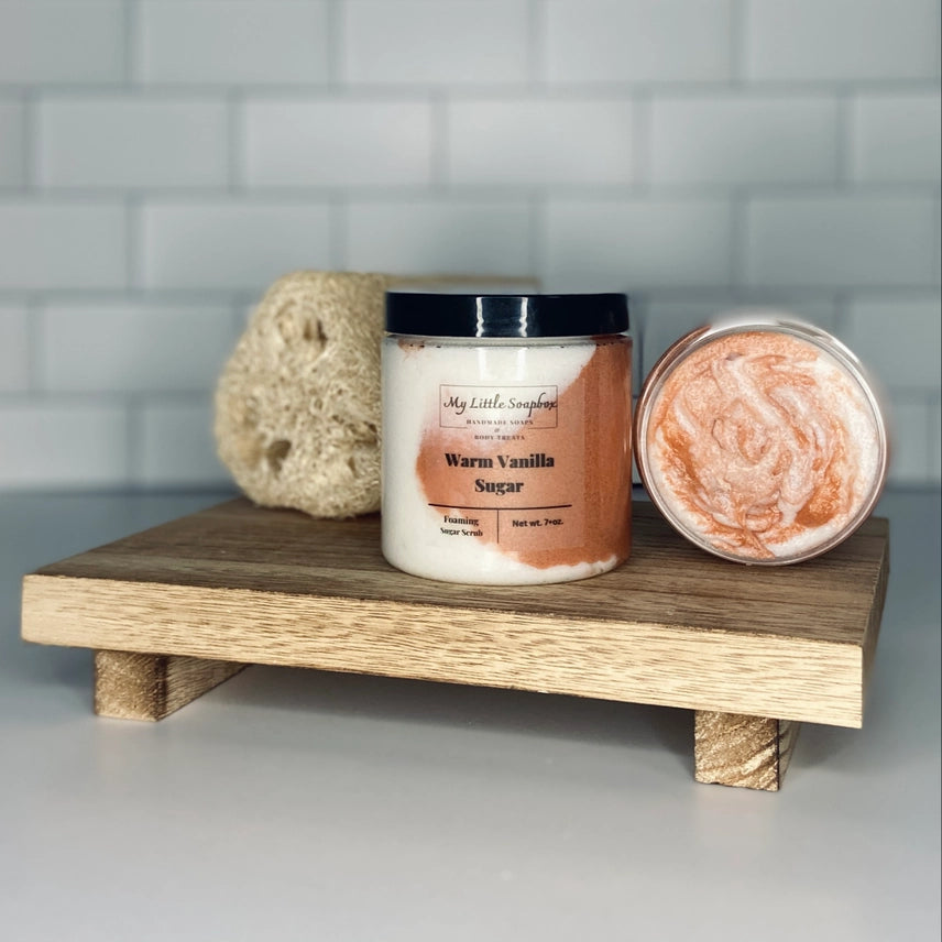 Warm vanilla foaming sugar scrub in jar with exfoliating body polish texture