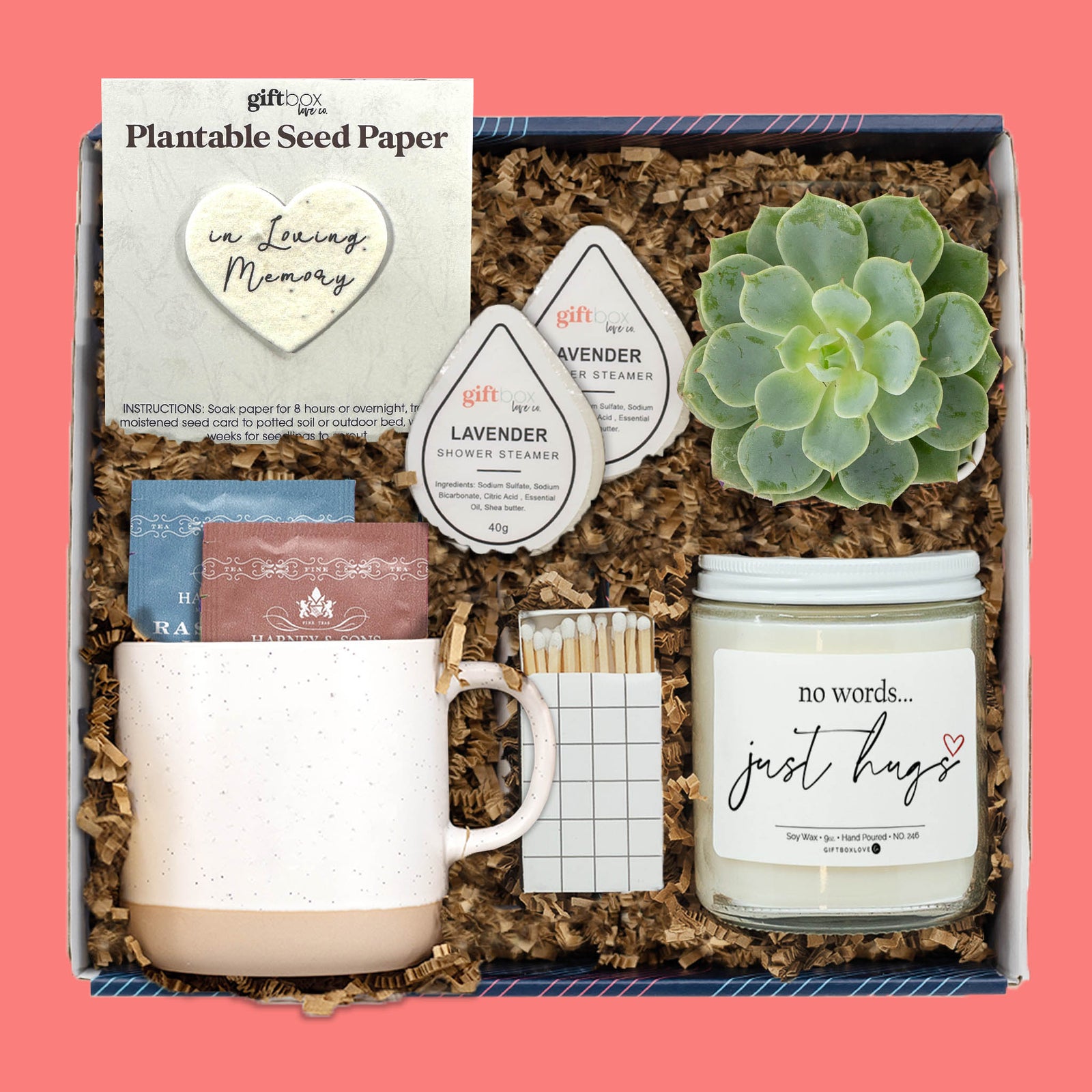 Comfort gift box with blanket, fuzzy socks, candle, bath soak, lavender soap, and matches on coral background