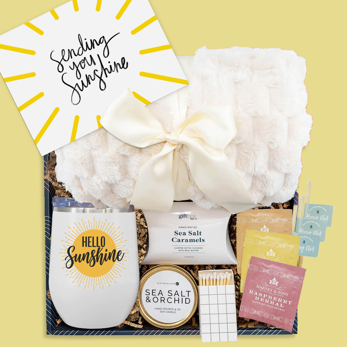 wrapped in sunshine gift box with plush blanket tumbler tea caramels candle and honey sticks