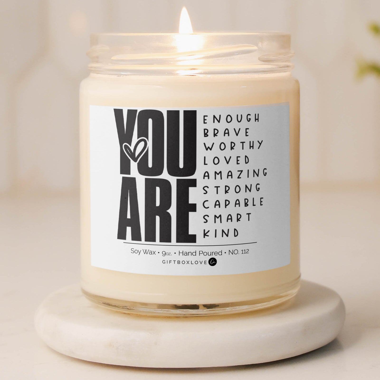 9 oz soy wax candle labeled "You Are Enough, Brave, Worthy, Loved, Amazing, Strong, Capable, Smart, Kind," with a Sea Salt & Orchid scent, perfect for self-care and encouragement.