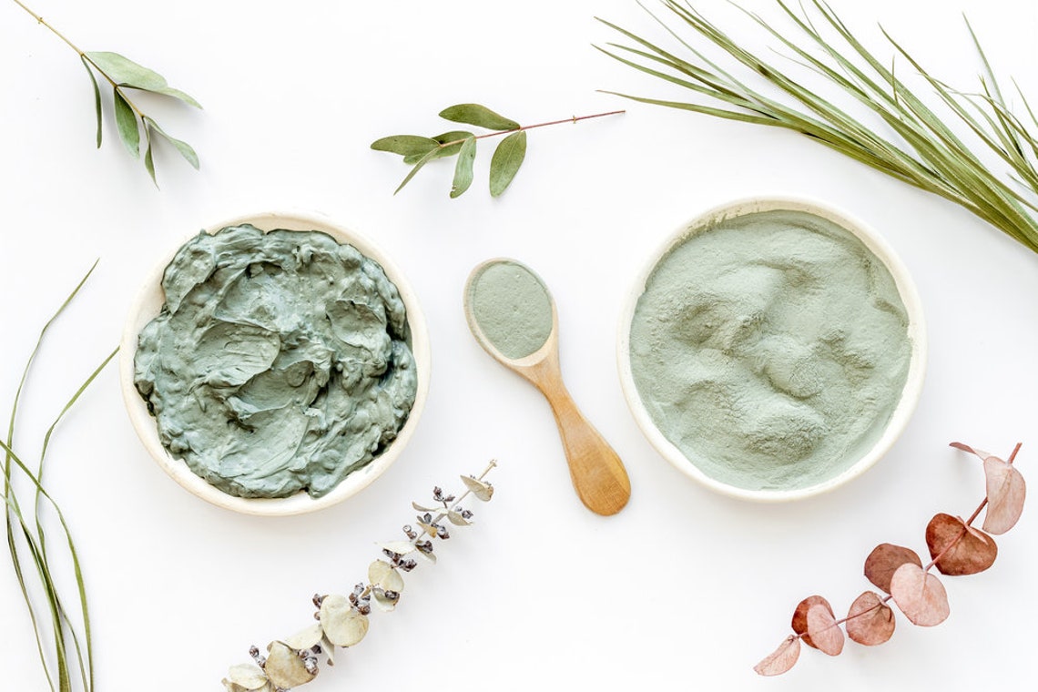 French clay mask powder and creamy texture displayed in bowls with greenery for skincare and spa gift boxes.